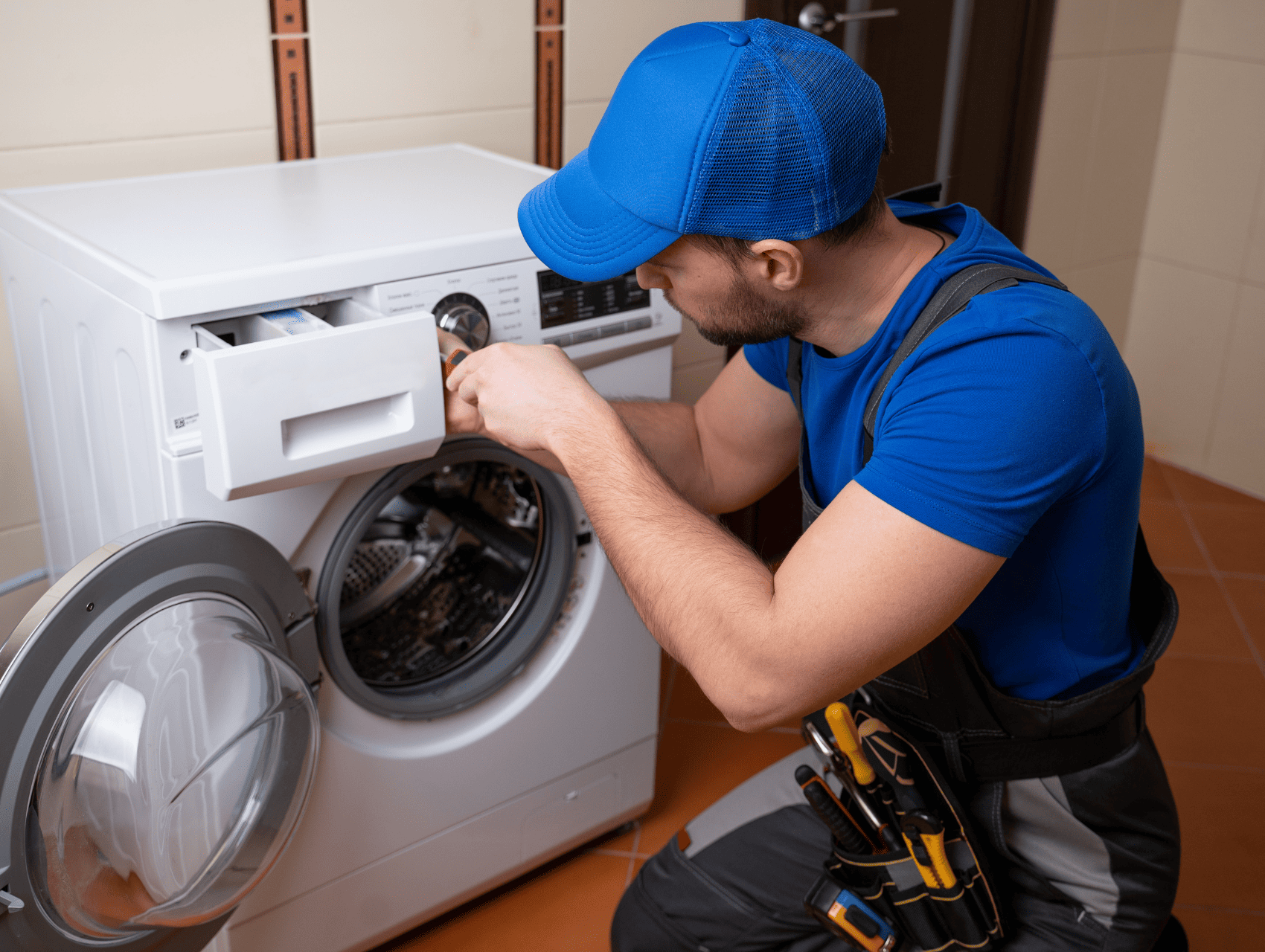 Technician repairing a malfunctioning washing machine at a home in Louisville, KY
